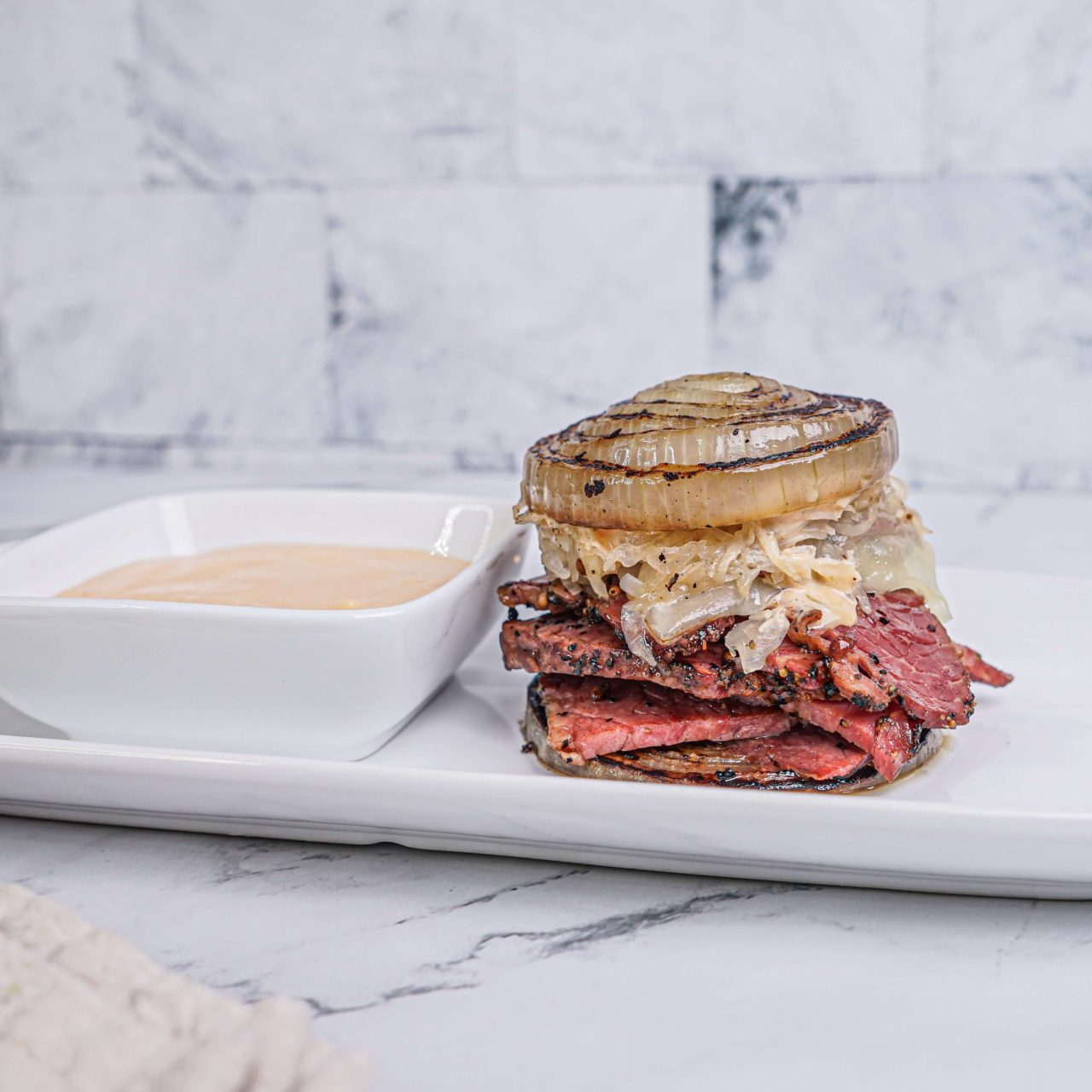 Flying Dutchman Reuben on a white plate with thousand island sauce