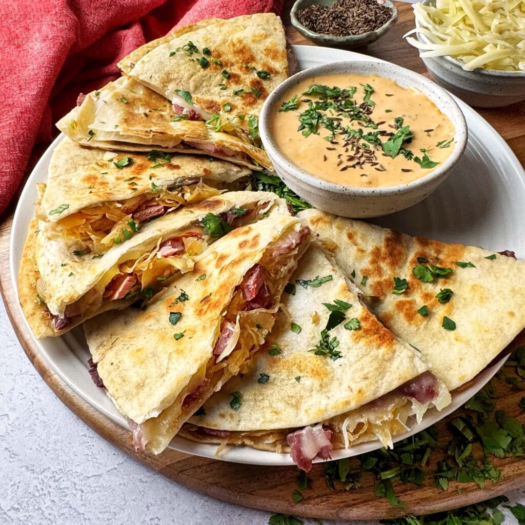Reuben Quesadilla with Frank's BBQ Kraut on a white plate.