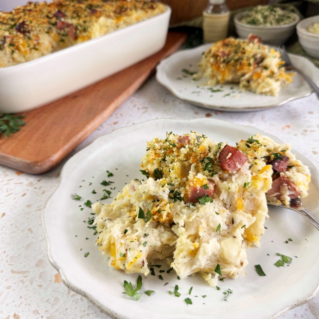 A white plate with a serving of Kraut and Mashed Potato Casserole.