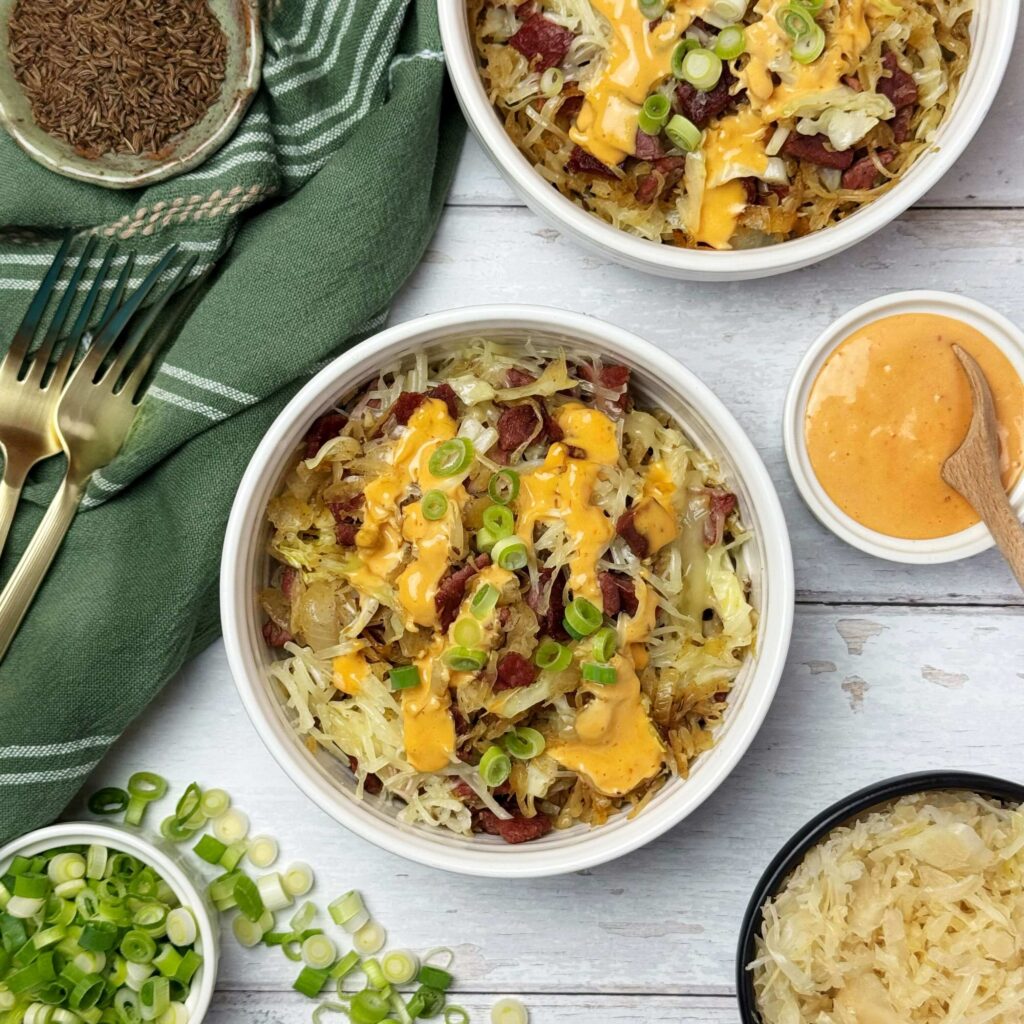 A white bowl of Easy Reuben Bowls with Cabbage and Frank's Kraut.