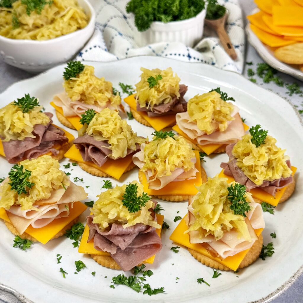 Kraut Stacks with Mustard Kraut, meat and cheese on a white serving plate.