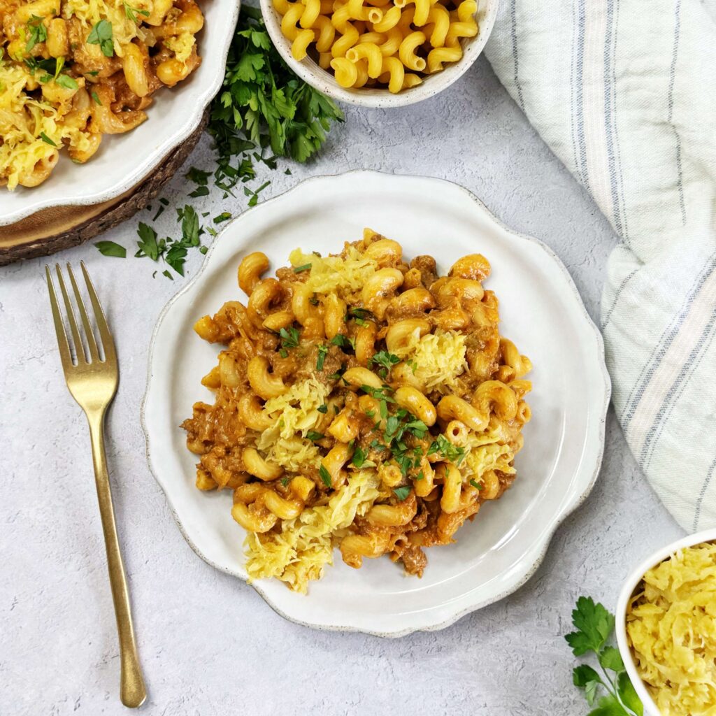 A white dinner plate with One Pot Cheeseburger Pasta Skillet with Mustard Kraut